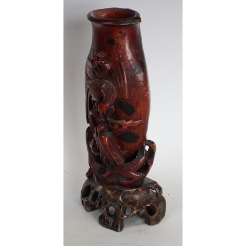 196 - A Chinese soapstone flattened vase, boldly carved with a skirmish between a phoenix and a ferocious ... 