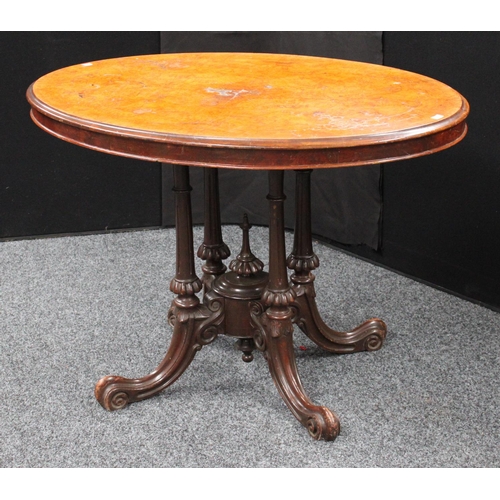 209 - A Victorian walnut centre table, elliptical top, cluster columnar support centred by a spire underfi... 