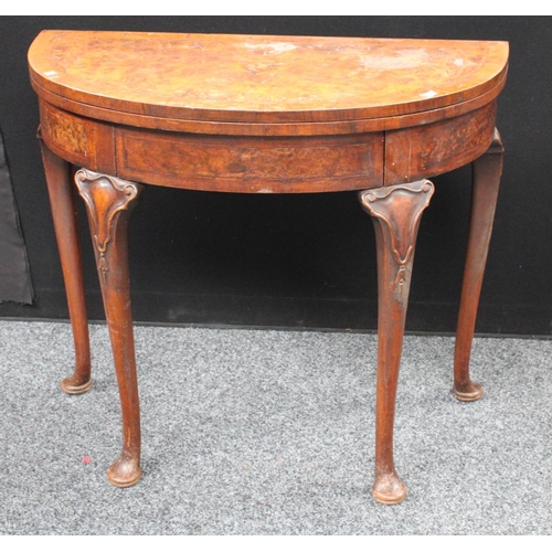 211 - A Queen Anne style walnut demilune card table, folding top enclosing a baize lined playing surface, ... 