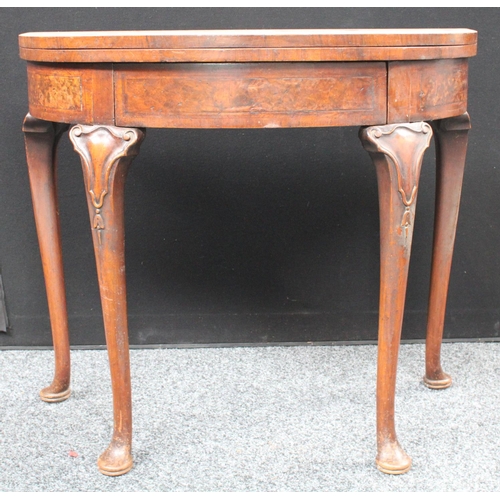 211 - A Queen Anne style walnut demilune card table, folding top enclosing a baize lined playing surface, ... 