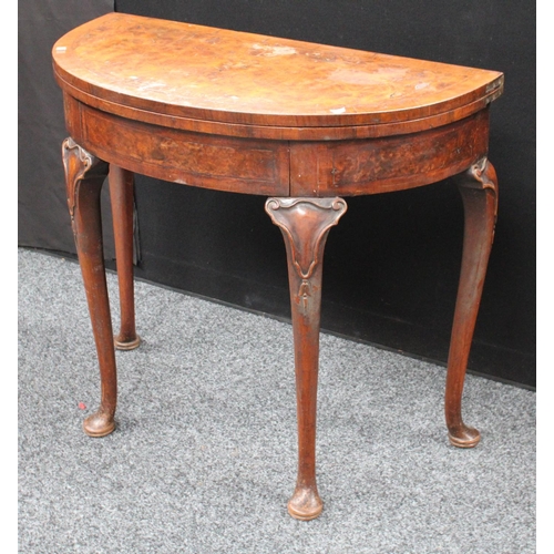 211 - A Queen Anne style walnut demilune card table, folding top enclosing a baize lined playing surface, ... 