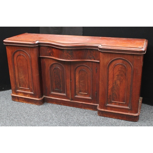 214 - A Victorian mahogany sideboard, inverted bowed break-centre above a frieze drawer and a pair of cupb... 