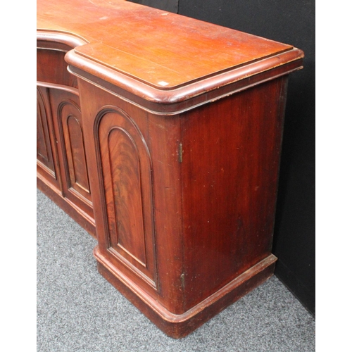 214 - A Victorian mahogany sideboard, inverted bowed break-centre above a frieze drawer and a pair of cupb... 