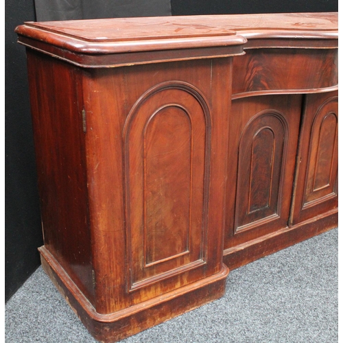 214 - A Victorian mahogany sideboard, inverted bowed break-centre above a frieze drawer and a pair of cupb... 