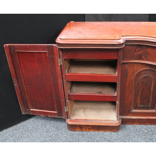 214 - A Victorian mahogany sideboard, inverted bowed break-centre above a frieze drawer and a pair of cupb... 