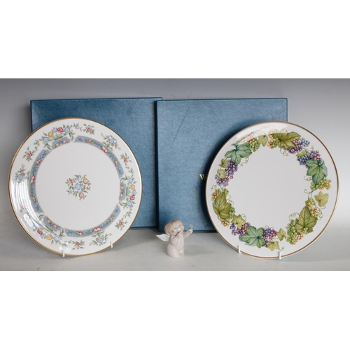 225 - A Royal Worcester cake plate, Mayfield pattern, boxed; another, Vine Harvest pattern, boxed; a Nao m... 