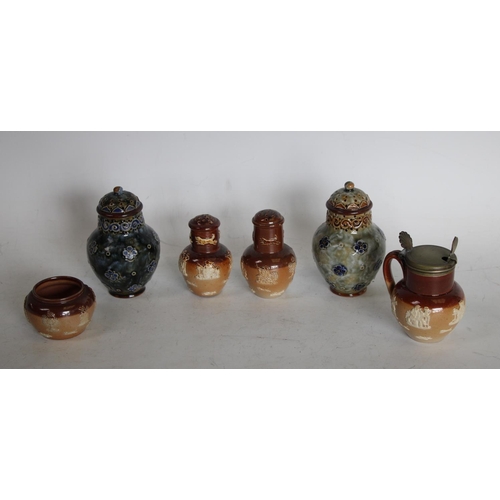 229 - A Doulton Lambeth baluster pepper pot, applied with stylised flowerheads, on a mottled olive ground,... 