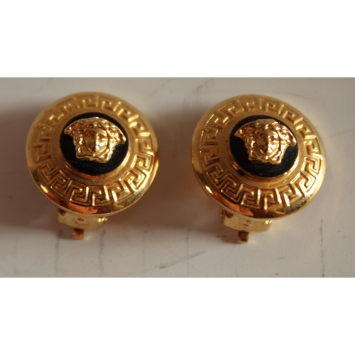 597 - A pair of Versace lady's yellow-metal clip earrings, each roundel centred by a mask of Medusa on a b... 