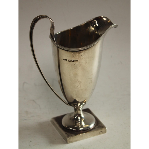 604 - A George V Adam Revival silver helmet shaped cream jug, Birmingham 1912