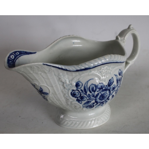 63 - A Worcester blue and white sauce boat, crisply moulded with overlapping scales painted with flowers ... 