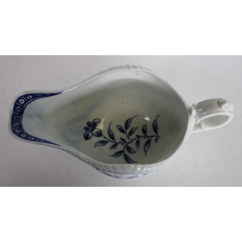 63 - A Worcester blue and white sauce boat, crisply moulded with overlapping scales painted with flowers ... 