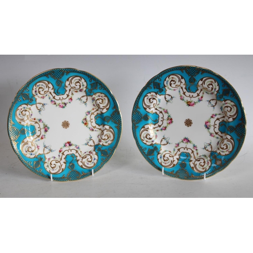 72 - A pair of Minton shaped circular cabinet plates, painted with swags of colourful flowers, turquoise ... 