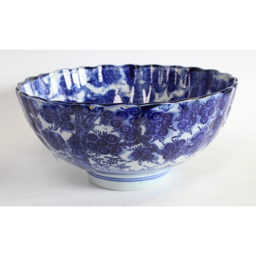 76 - An early 20th century Chinese blue and white bowl, shaped lip, 24cm diameter, another similar, large... 