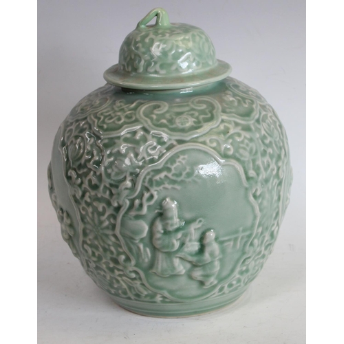 77 - A Chinse celadon ovoid wine jar and cover, moulded in relief with four reserves of traditional figur... 