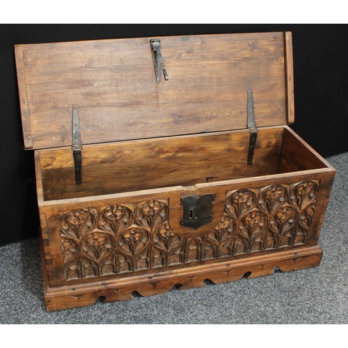 155 - A hardwood blanket chest, in the 15th century High Gothic taste, hinged top above a profuesly carved... 