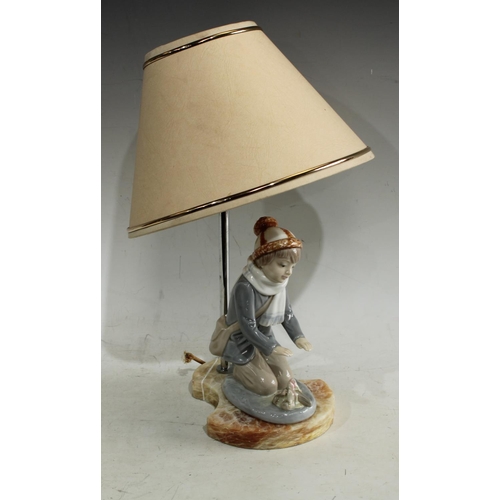 173 - An lamp as a kneeling boy, on alabaster base