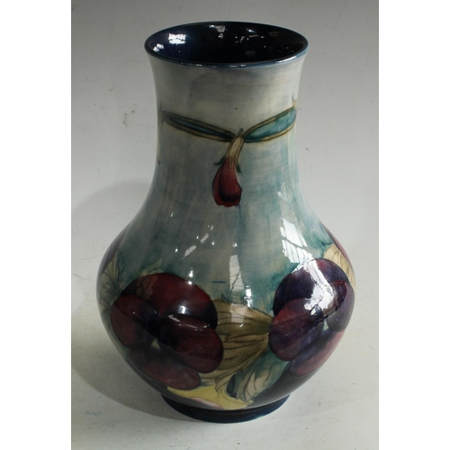 180 - A Moorcroft Pansy pattern vase, signed Walter Moorcroft, approx 28cm high