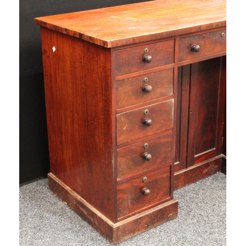 205 - A Victorian mahogany kneehole desk, oversailing rectangular top above three frieze drawers, a pair o... 