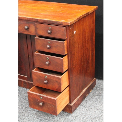 205 - A Victorian mahogany kneehole desk, oversailing rectangular top above three frieze drawers, a pair o... 