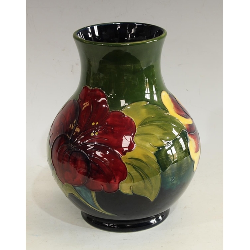 214 - A Moorcroft Hibiscus pattern vase, signed Walter Moorcroft, approx 25cm high