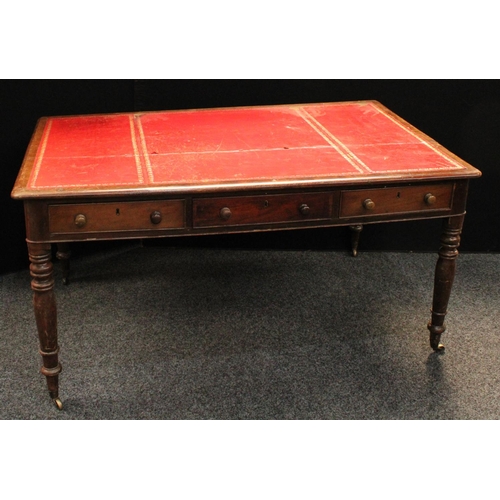 231 - A Victorian mahogany library table, rounded rectangular top with inset writing surface above three f... 