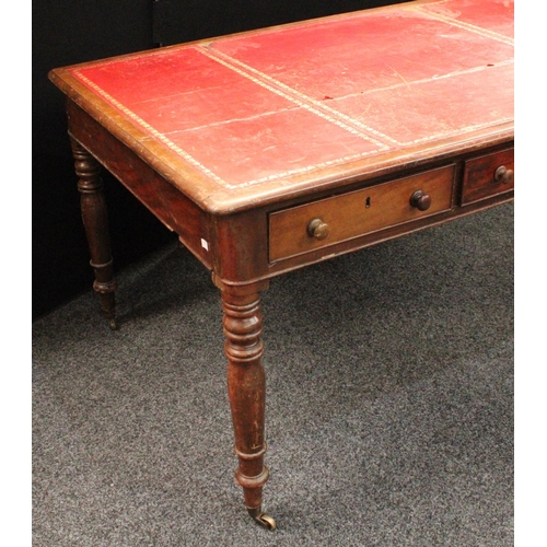 231 - A Victorian mahogany library table, rounded rectangular top with inset writing surface above three f... 