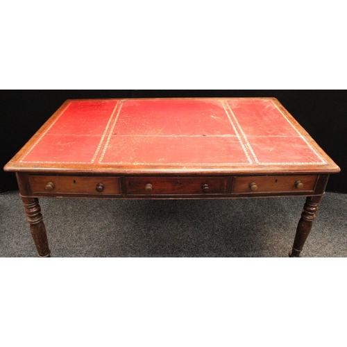 231 - A Victorian mahogany library table, rounded rectangular top with inset writing surface above three f... 