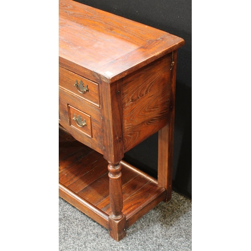 234 - A George III style oak low dresser, oversailing rectangular top above an arrangement of drawers, pla... 