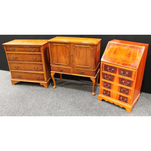 235 - A yew chest of four long drawers, 92cm high, 86cm wide; a similar side cabinet and bureau (3)