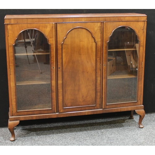 240 - An early 20th century walnut triple-door display cabinet, c.1935