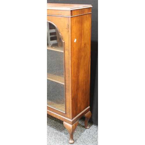 240 - An early 20th century walnut triple-door display cabinet, c.1935