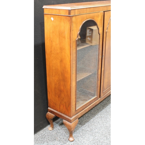 240 - An early 20th century walnut triple-door display cabinet, c.1935