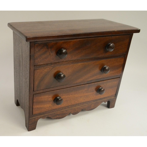 3028 - A 19th century mahogany miniature chest of drawers, oversailing top above three long graduated drawe... 