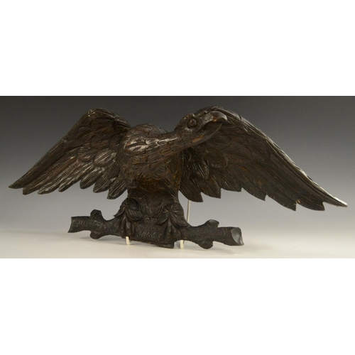 3032 - A 19th century oak cresting, boldly carved as an eagle, 55.5cm wide, c. 1880