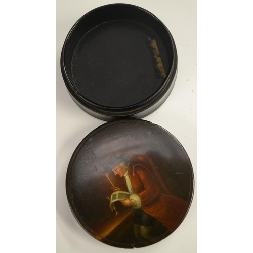 3033 - A 19th century papier-mâché circular table-top snuff box, the cover humorously painted with a gentle... 