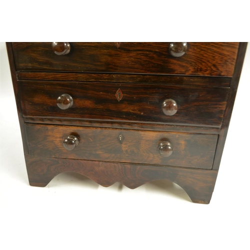 3037 - A 19th century rosewood miniature chest of collectors drawers, oversailing top above two short and t... 