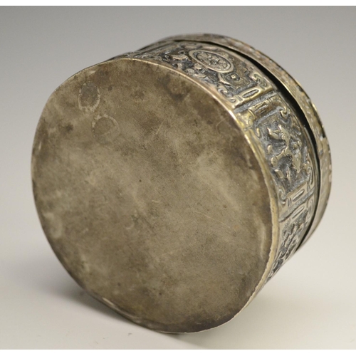 3041 - A 19th century silver coloured metal circular box and cover, possibly Turkish, chased overall with s... 