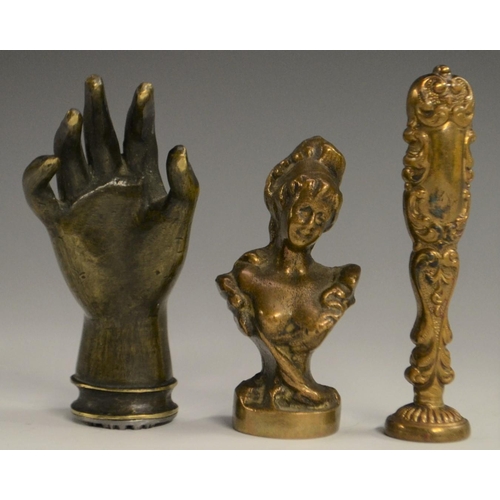 3058 - A bronze novelty desk seal, as a hand, 7.5cm long; others (3)