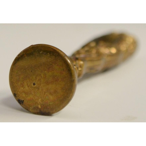 3058 - A bronze novelty desk seal, as a hand, 7.5cm long; others (3)