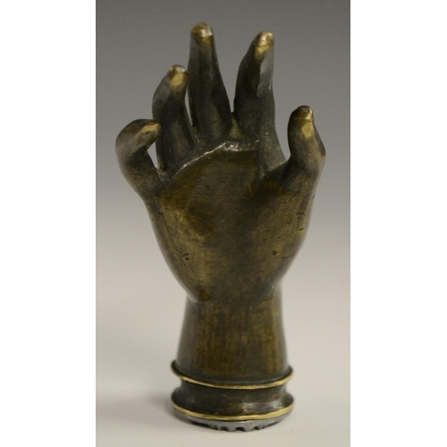 3058 - A bronze novelty desk seal, as a hand, 7.5cm long; others (3)