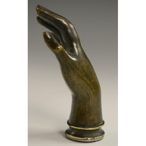 3058 - A bronze novelty desk seal, as a hand, 7.5cm long; others (3)