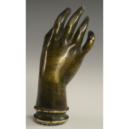 3058 - A bronze novelty desk seal, as a hand, 7.5cm long; others (3)