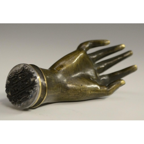 3058 - A bronze novelty desk seal, as a hand, 7.5cm long; others (3)