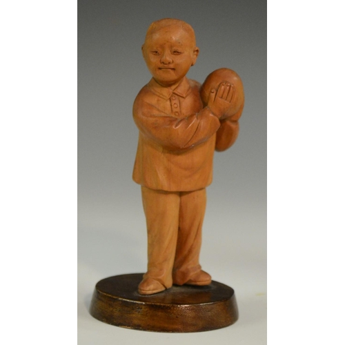 3063 - A Chinese boxwood figure, carved as a young boy holding a peach, 10.5cm high; another; a Chinese tig... 