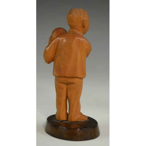 3063 - A Chinese boxwood figure, carved as a young boy holding a peach, 10.5cm high; another; a Chinese tig... 