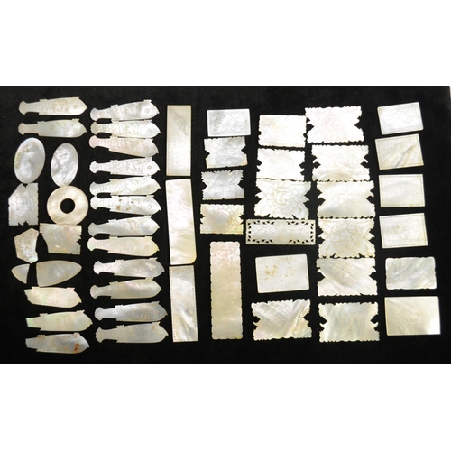 3078 - A collection of Chinese mother-of-pearl gaming counters, various shapes, including fish, engraved, C... 