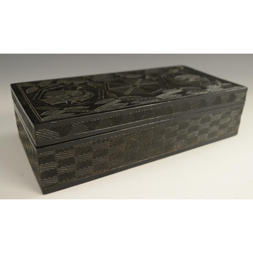 3079 - A Colonial ebony box and cover, carved in relief with stylised birds, palm leaves and geometric moti... 