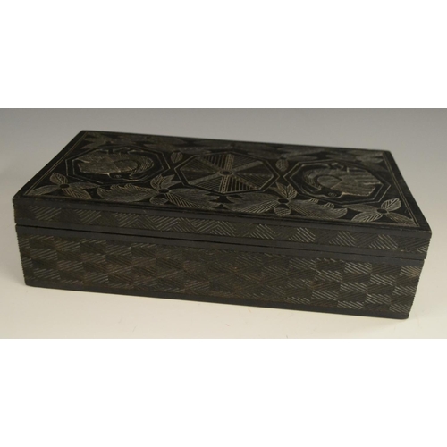 3079 - A Colonial ebony box and cover, carved in relief with stylised birds, palm leaves and geometric moti... 