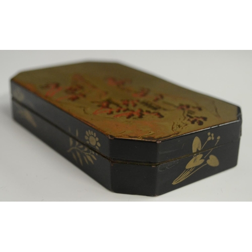 3103 - A Japanese export lacquer canted rectangular box, hinged cover decorated with a monumental lanscape,... 