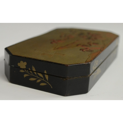 3103 - A Japanese export lacquer canted rectangular box, hinged cover decorated with a monumental lanscape,... 